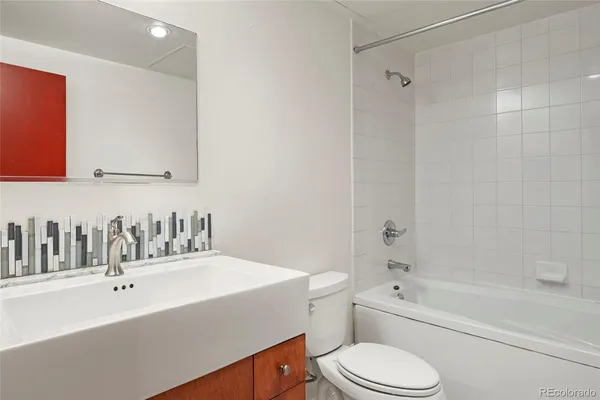 a bathroom with a sink a toilet and bathtub