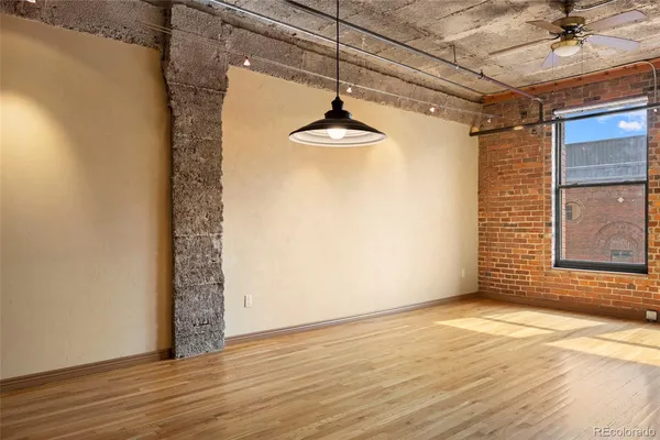 a view of a room with wooden floor and a window