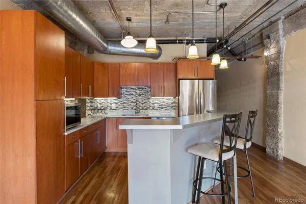 a kitchen with stainless steel appliances granite countertop a sink and cabinets