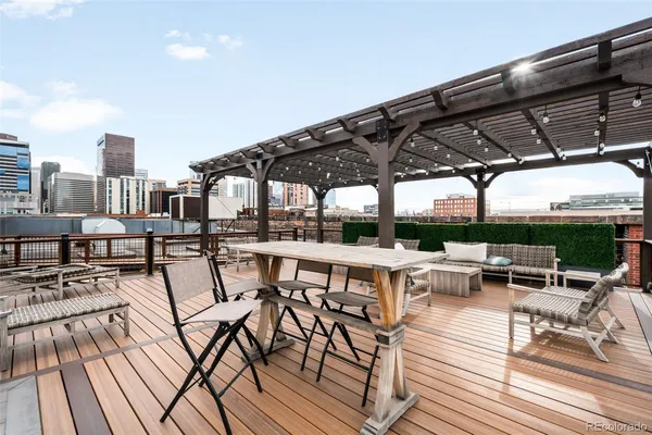 a view of a roof deck with table and chairs