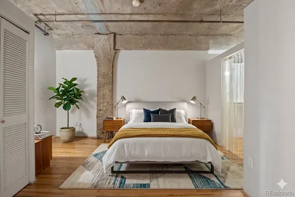 a bedroom with a bed and a potted plant