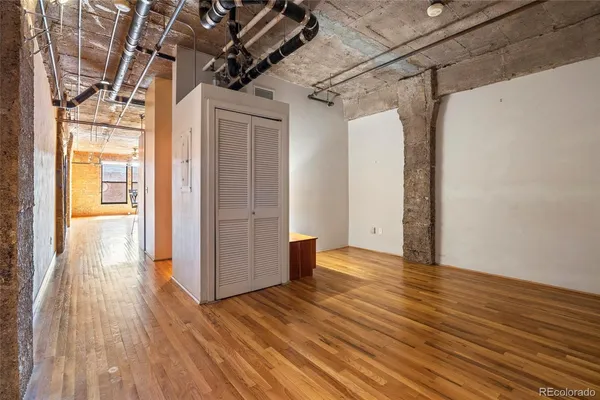 a view of a room with wooden floor