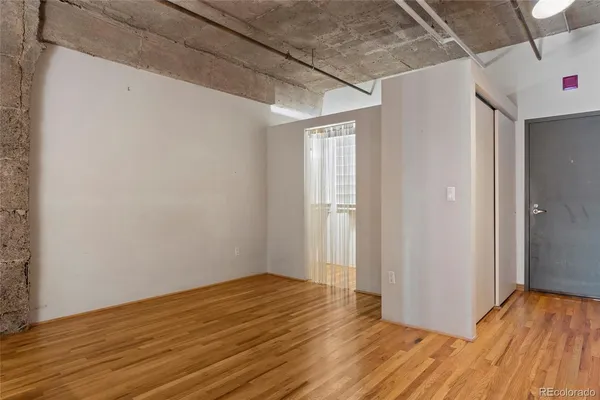 a view of a room with wooden floor