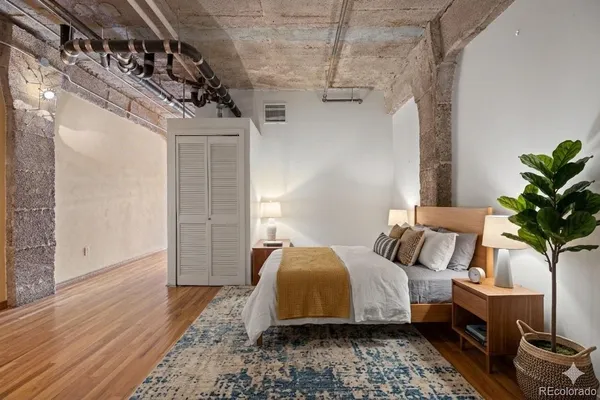 a bedroom with bed and a potted plant