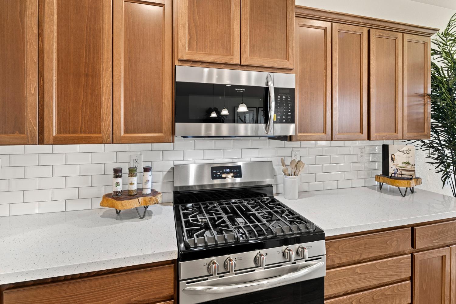 1727 Dos Rios Court Plumas Lake, CA 95961 - Photo 14 of 43 a kitchen with stainless steel appliances a stove and cabinets