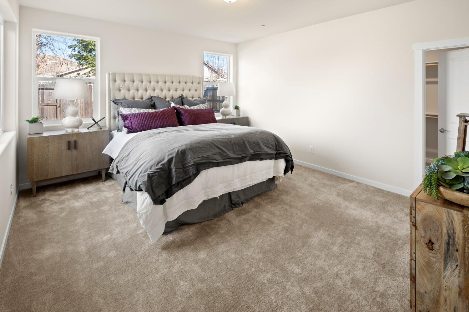 1727 Dos Rios Court Plumas Lake, CA 95961 - Photo 19 of 43 a bedroom with a bed lamp and a potted plant