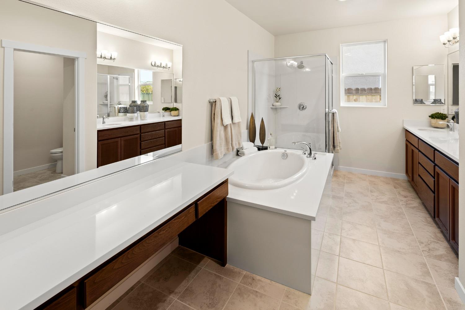 1727 Dos Rios Court Plumas Lake, CA 95961 - Photo 21 of 43 a large bathroom with a double vanity sink a mirror and a bathtub