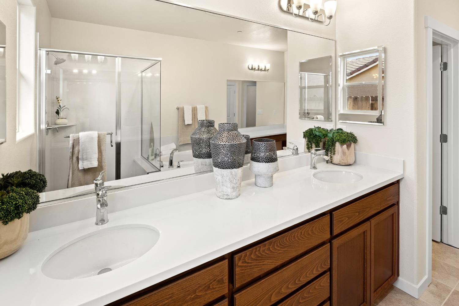 1727 Dos Rios Court Plumas Lake, CA 95961 - Photo 22 of 43 a bathroom with a sink a mirror and vanity