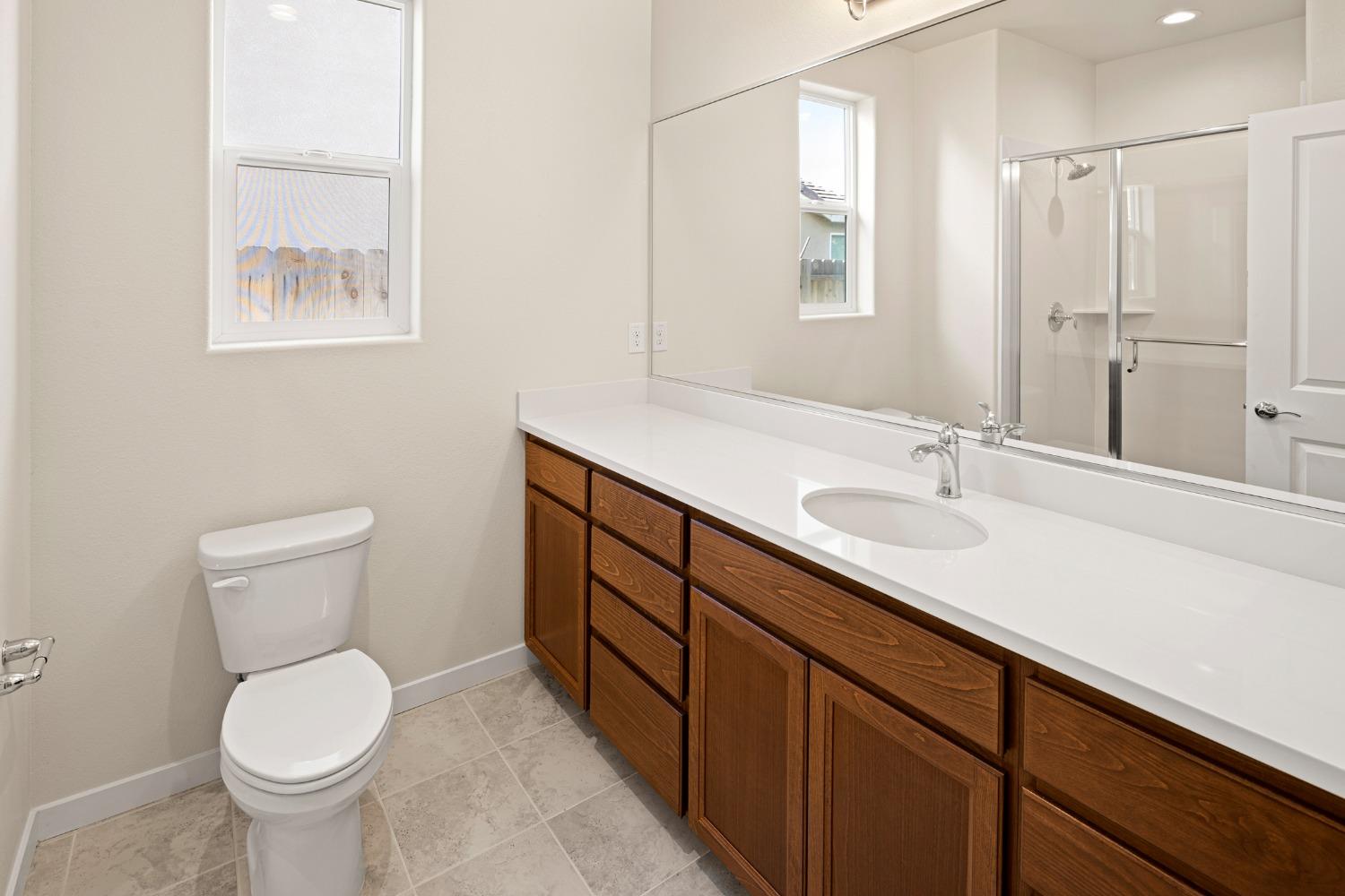 1727 Dos Rios Court Plumas Lake, CA 95961 - Photo 26 of 43 a bathroom with a sink toilet and vanity