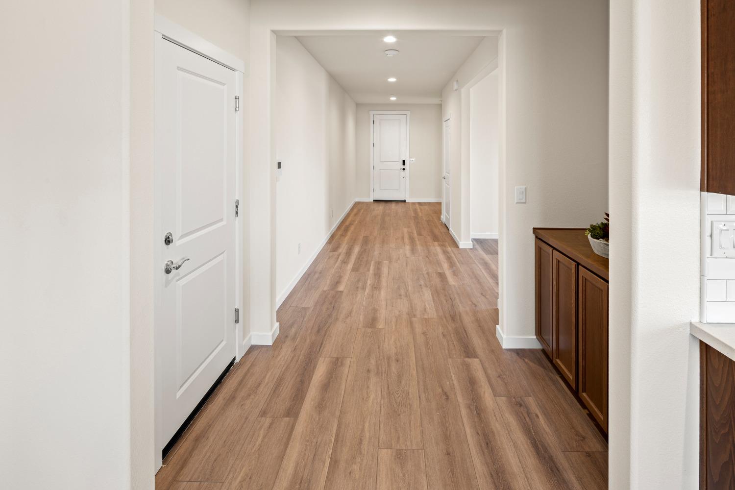 1727 Dos Rios Court Plumas Lake, CA 95961 - Photo 4 of 43 a view of a hallway with wooden floor and staircase