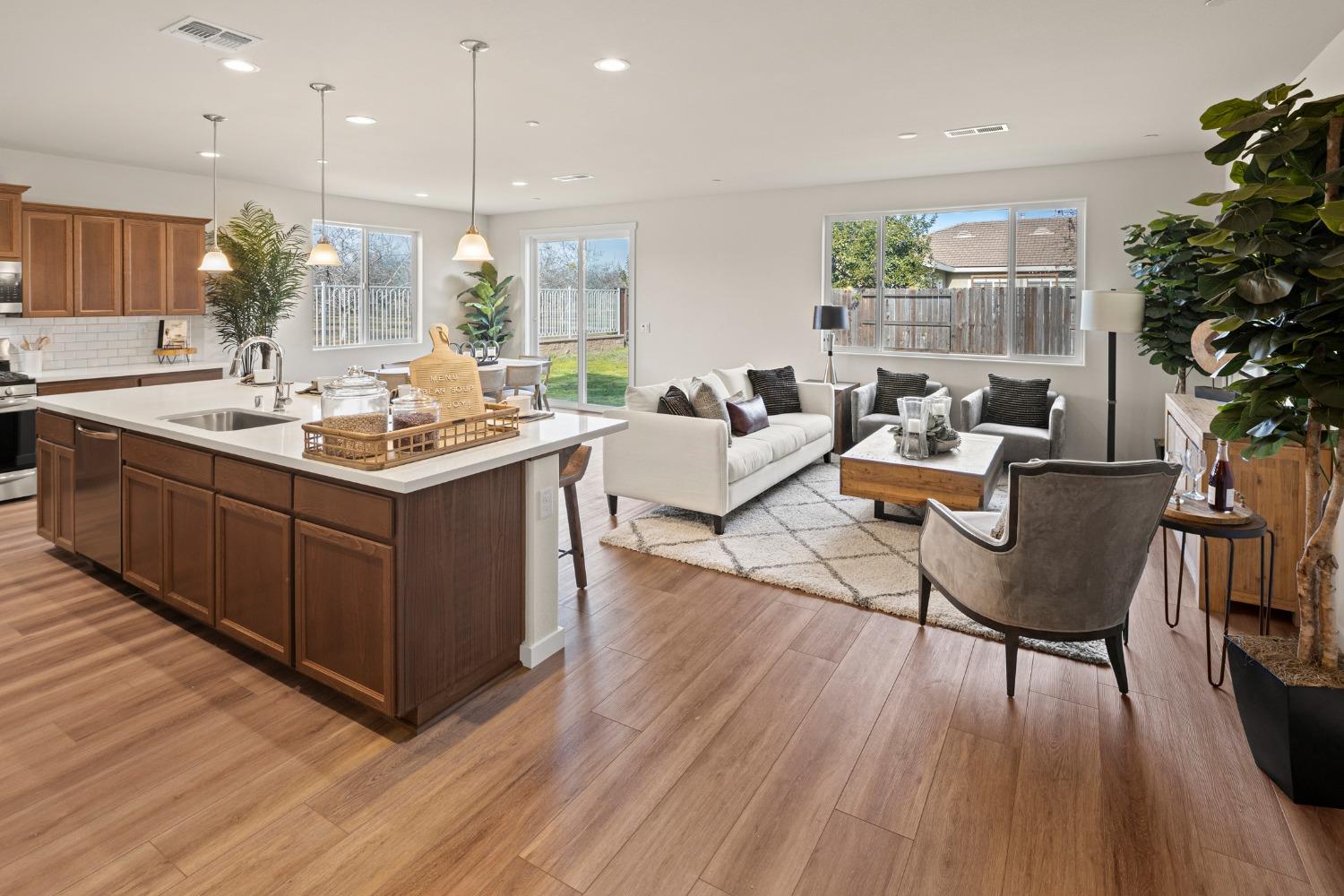 1727 Dos Rios Court Plumas Lake, CA 95961 - Photo 5 of 43 a kitchen with a table chairs stove and cabinets