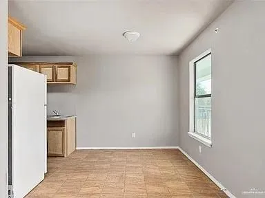 a view of a kitchen with a sink dishwasher and a refrigerator