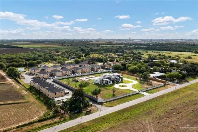 an aerial view of residential houses with outdoor space