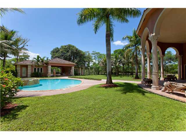 11688 Old Pump House Road Boca Raton, FL 33498 - Photo 18 of 25 a view of a house with swimming pool and a yard