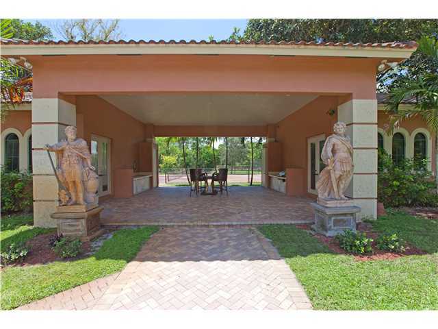 11688 Old Pump House Road Boca Raton, FL 33498 - Photo 19 of 25 a front view of a house with yard and lake view