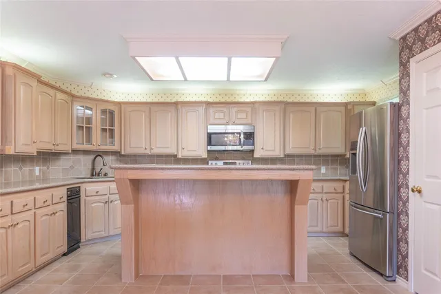 a kitchen with stainless steel appliances a refrigerator sink and cabinets