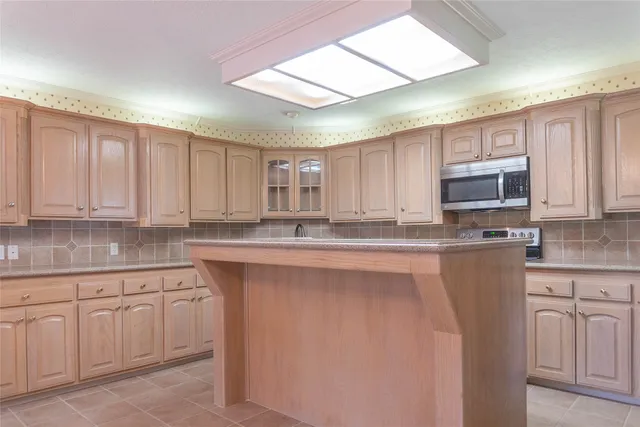 a kitchen with white cabinets sink and stainless steel appliances
