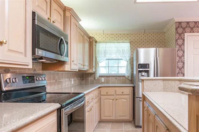a kitchen with stainless steel appliances granite countertop a sink and a stove