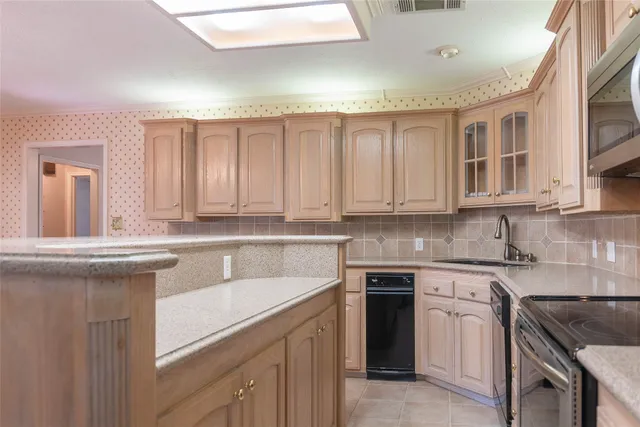a kitchen with stainless steel appliances granite countertop a sink stove and cabinets