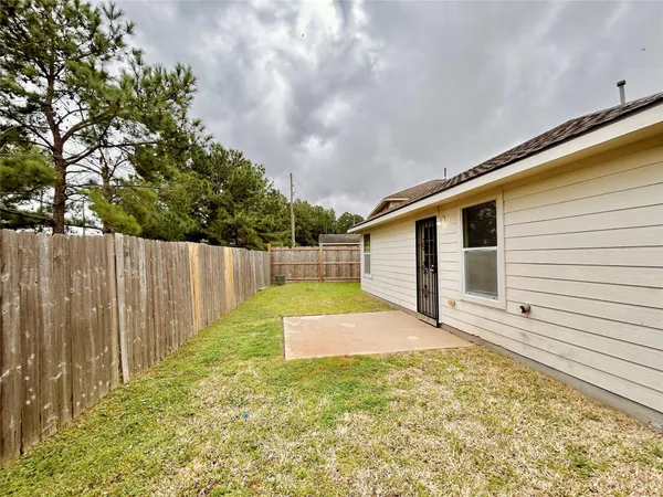 a backyard of a house with wooden fence