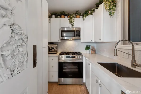 a kitchen with stainless steel appliances granite countertop a stove and a sink