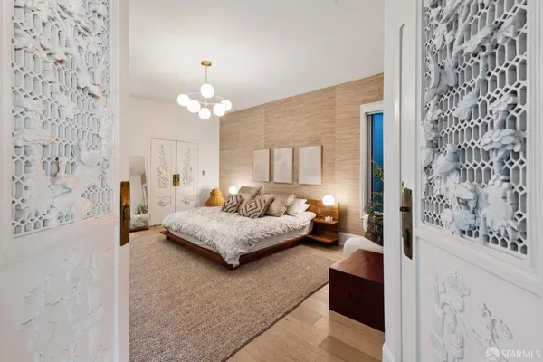 a spacious bedroom with a bed couch and window