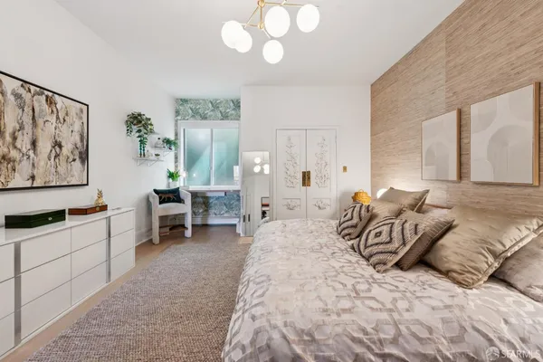 a bedroom with furniture and a chandelier