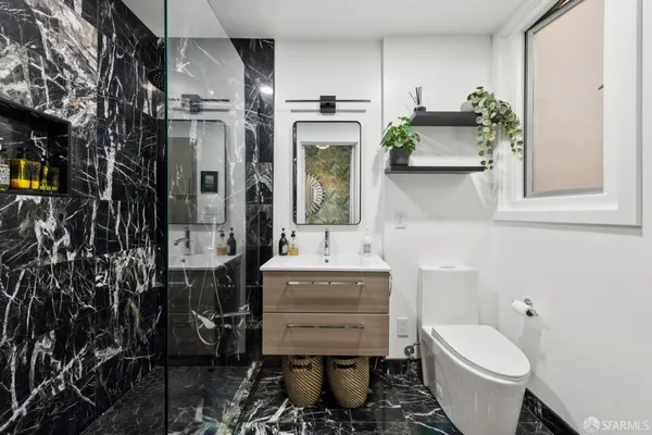 a bathroom with a sink toilet and shower