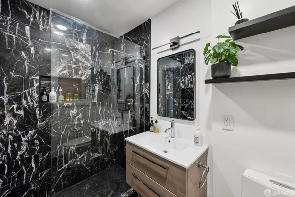 a bathroom with a sink toilet and shower