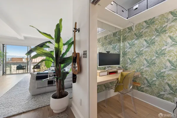 a living room with furniture and a potted plant