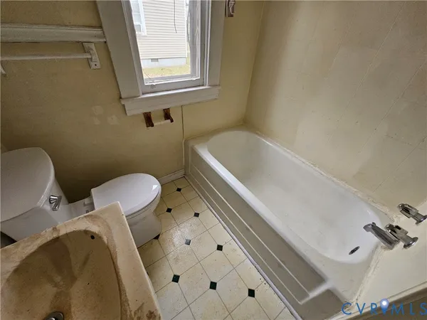 a bathroom with a sink a toilet and a bathtub
