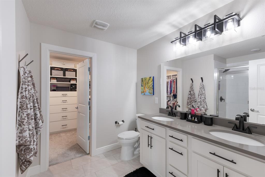 8985 Royal River Circle Parrish, FL 34219 - Photo 21 of 71 a bathroom with a double vanity sink mirror and toilet