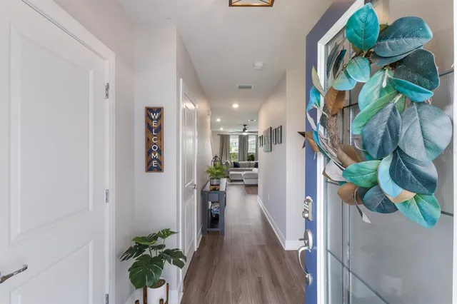 a view of a hallway with wooden floor and stairs