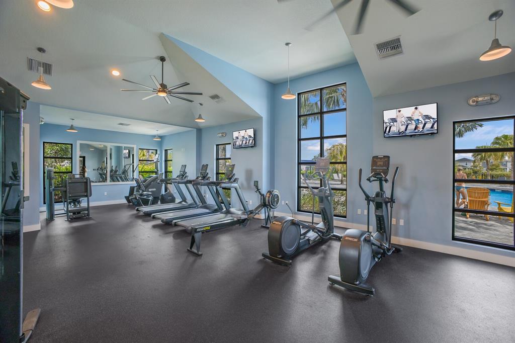 8985 Royal River Circle Parrish, FL 34219 - Photo 32 of 71 a living room with furniture gym equipment and a large window