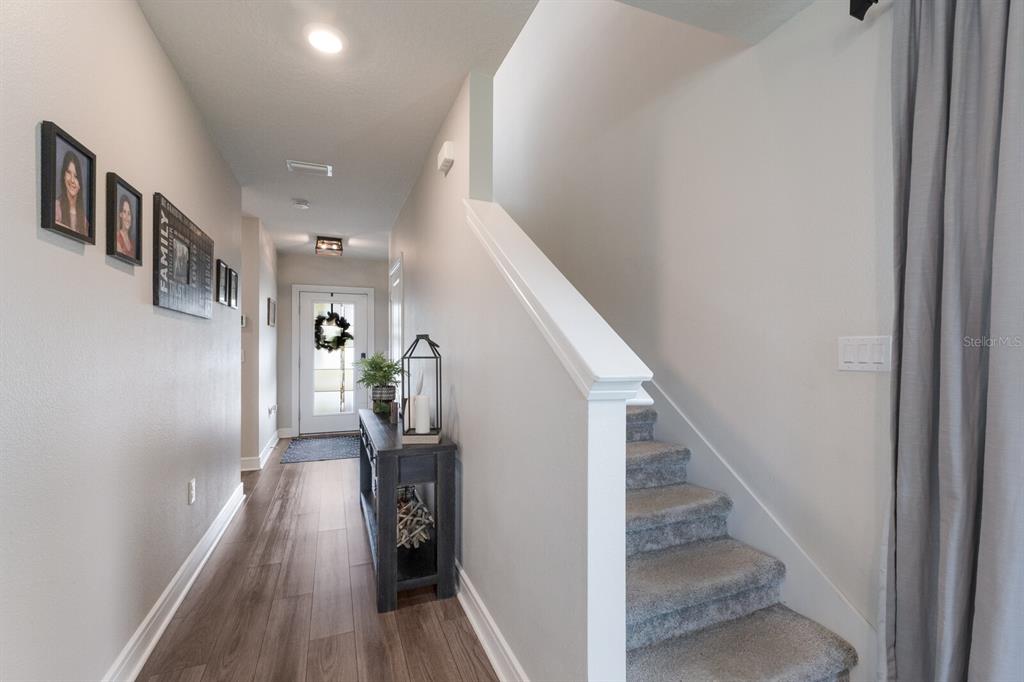 8985 Royal River Circle Parrish, FL 34219 - Photo 4 of 71 a view of a hallway with wooden floor and stairs
