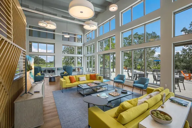 a sign of golf club on a wall under a tree