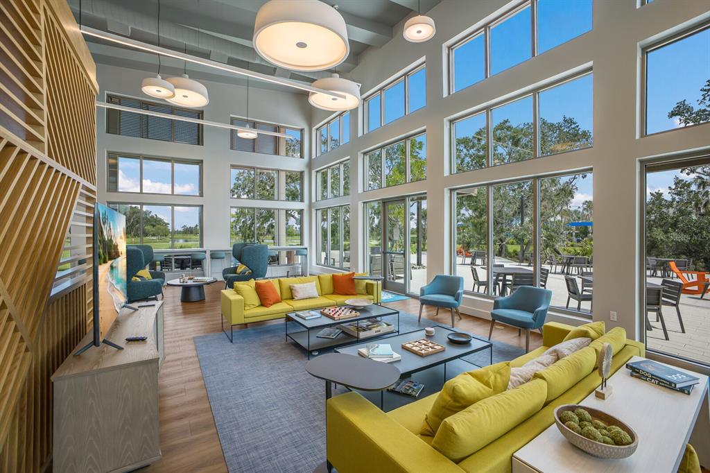 8985 Royal River Circle Parrish, FL 34219 - Photo 50 of 71 a living room with furniture and floor to ceiling windows