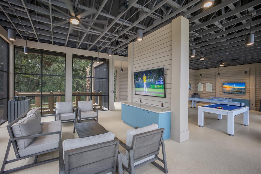 8985 Royal River Circle Parrish, FL 34219 - Photo 56 of 71 a living room with furniture a table and chairs