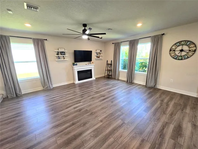 a kitchen with stainless steel appliances granite countertop a sink a stove a refrigerator and island