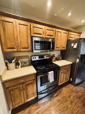 a kitchen with stainless steel appliances a stove a microwave sink and cabinets