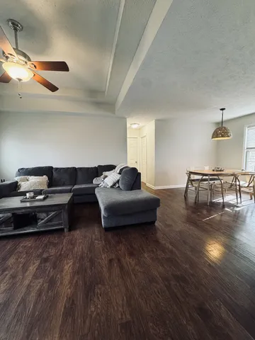 a living room with furniture and a wooden floor