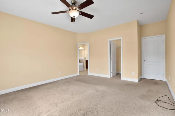 a view of a big room with wooden floor and windows in a room