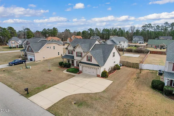 an aerial view of a house with a yard and lake view