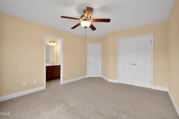 a view of an empty room with a ceiling fan