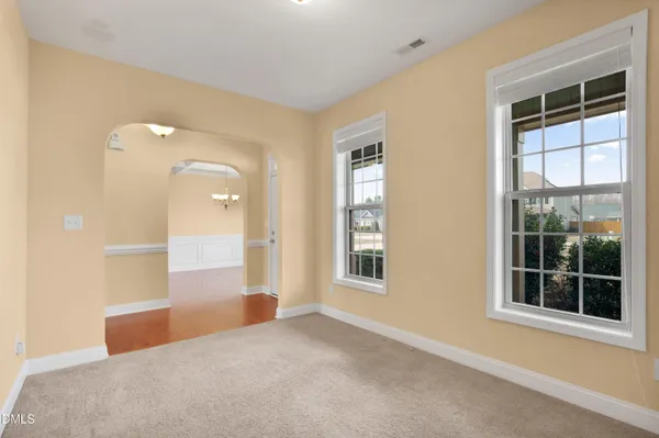 an empty room with windows and entrance