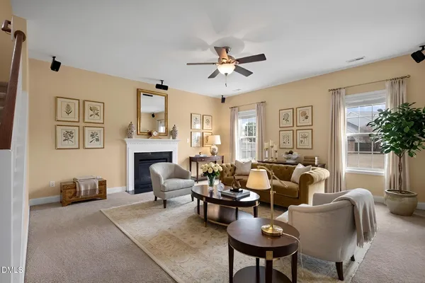 a living room with furniture potted plant and a window