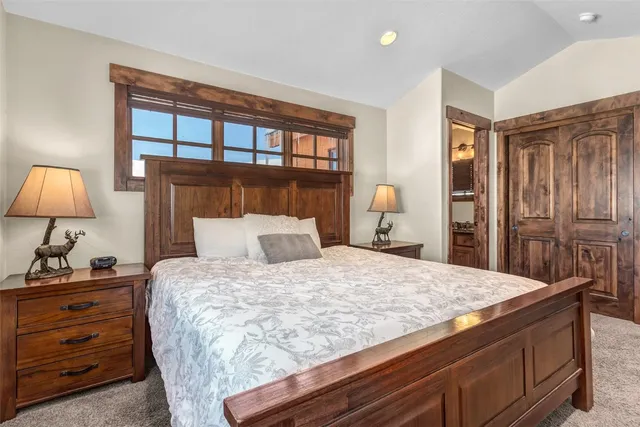 a bedroom with a bed and a night stand