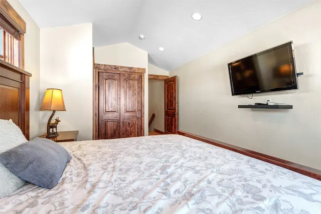 a bedroom with a bed and a flat screen tv