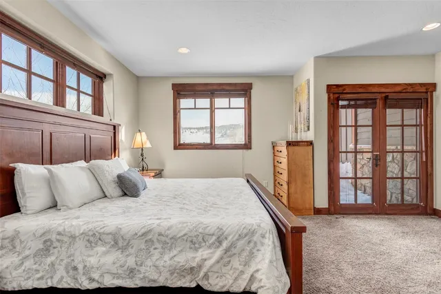 a bedroom with a large bed and a window