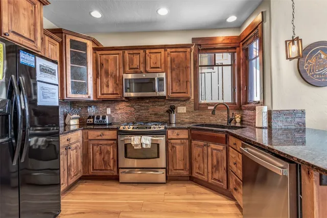 a kitchen with stainless steel appliances granite countertop a stove and a sink